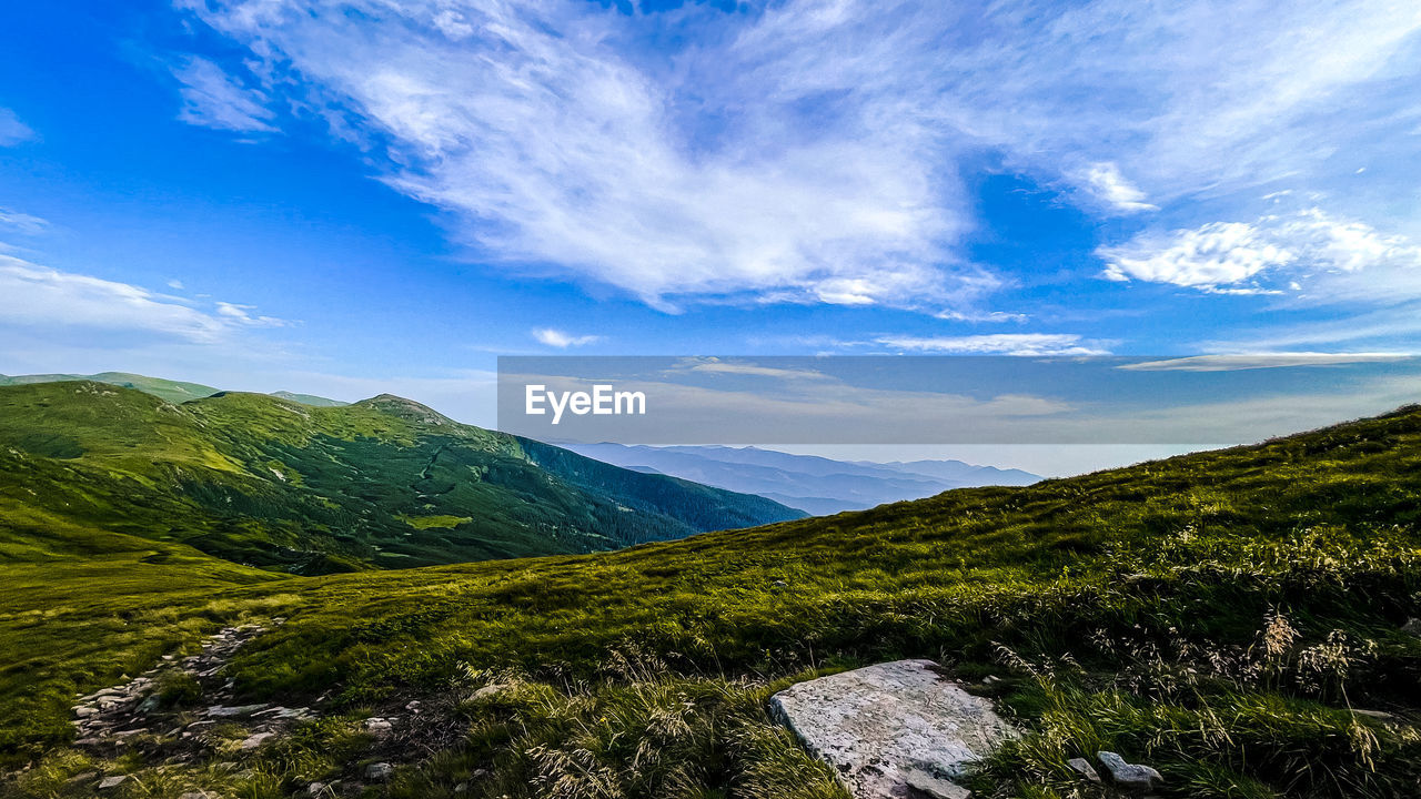 SCENIC VIEW OF MOUNTAINS AGAINST BLUE SKY