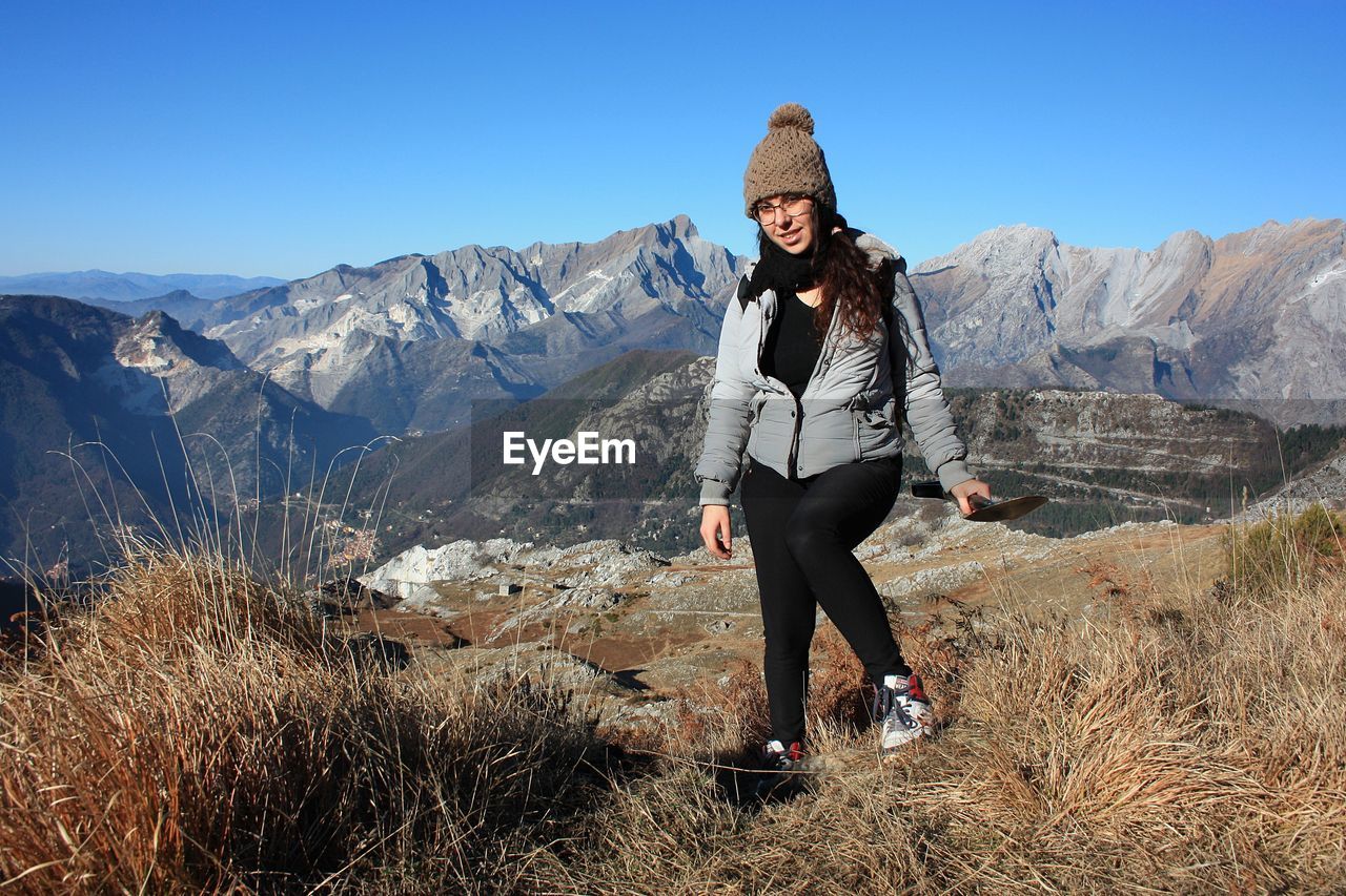 Explorer girl on adventure excursion in mountain of tuscan-emilian apennines. apuan alps on cold day