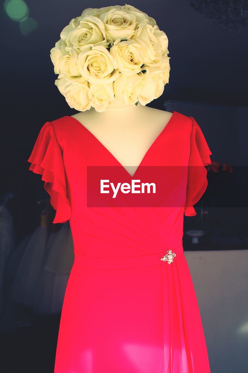 Mannequin in red dress with rose head