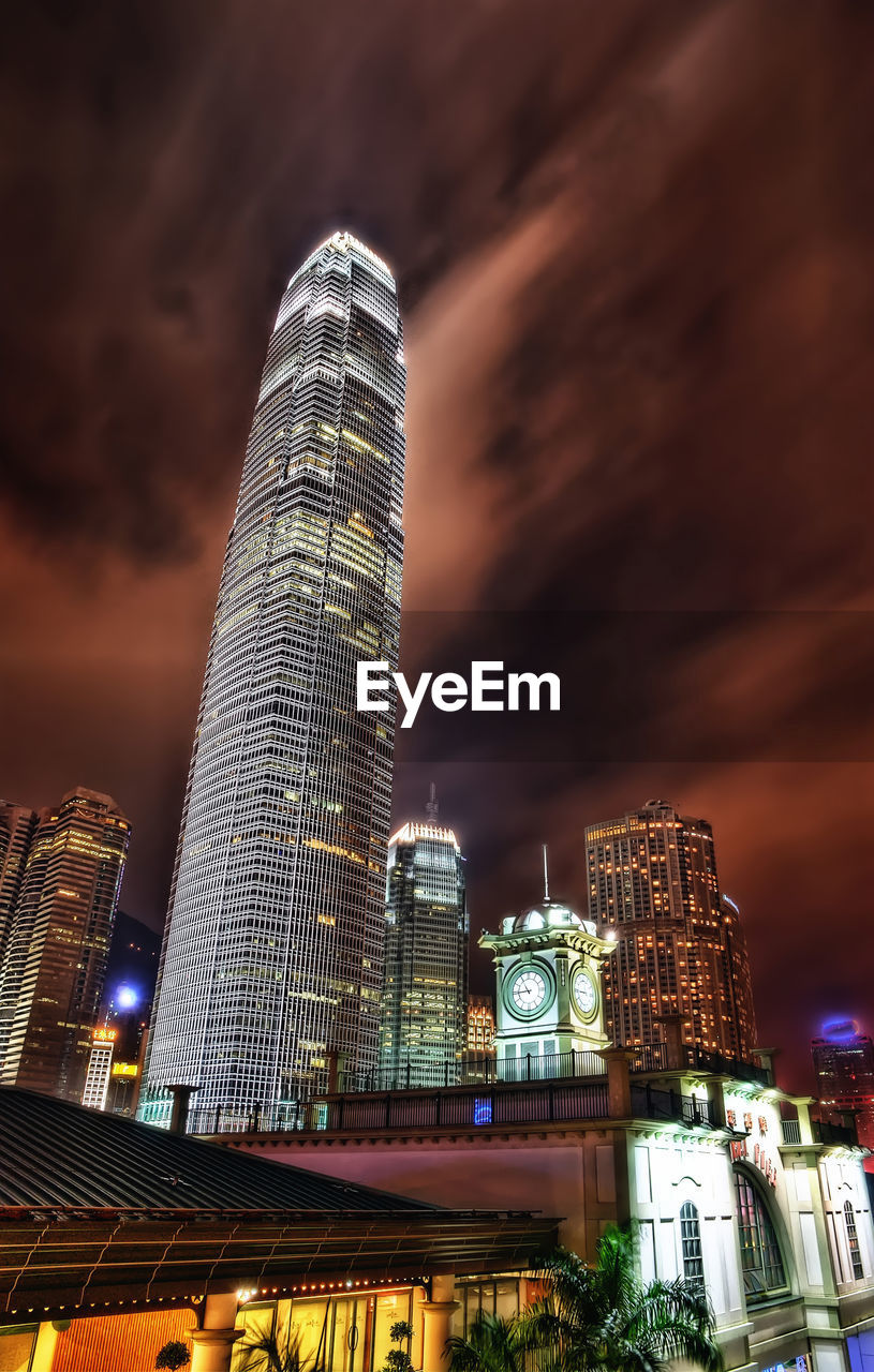 Low angle view of illuminated buildings against sky at night