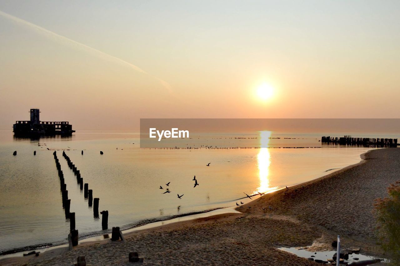 Scenic view of sea against sky during sunset