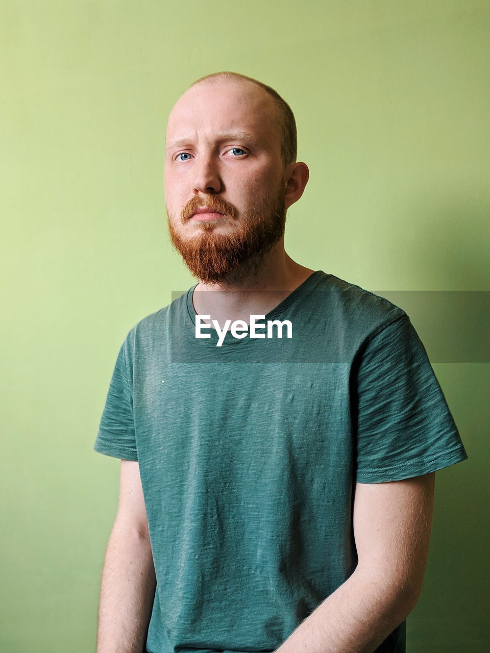 Portrait of man against green background