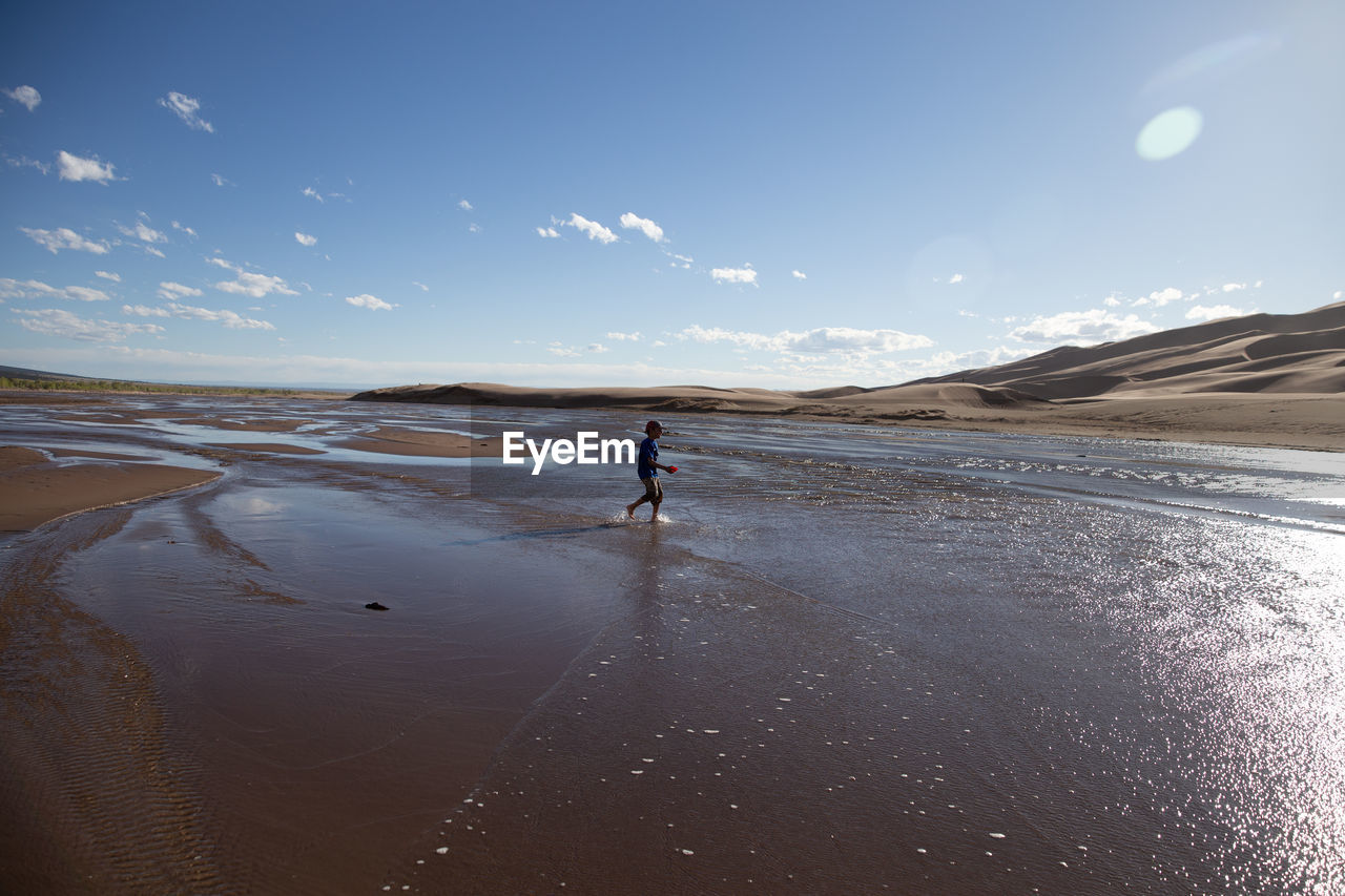 Boy walking at beach