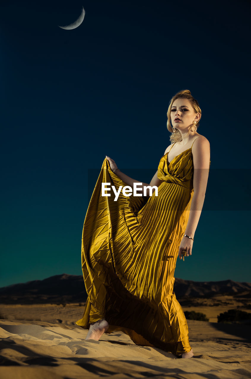 PORTRAIT OF WOMAN AGAINST SKY