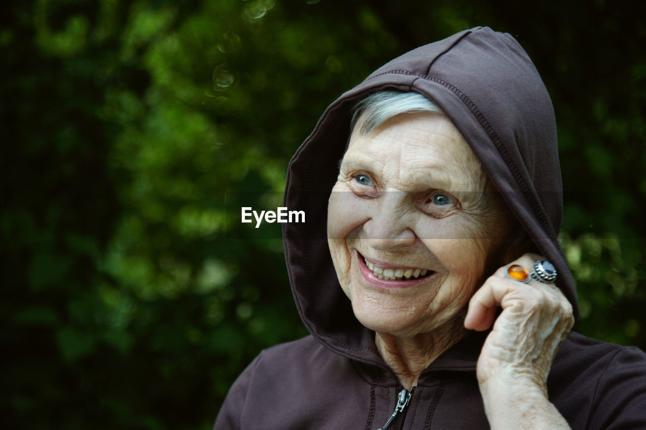 Close-up of smiling senior woman looking away