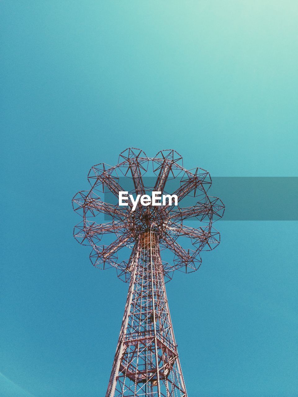 Low angle view of parachute jump ride in coney island against clear sky