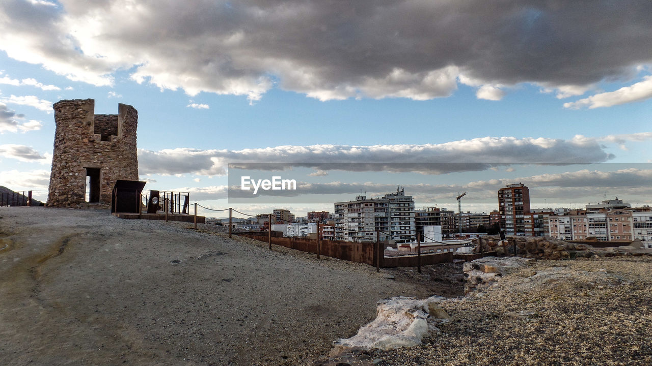 BUILDINGS ON BEACH AGAINST SKY