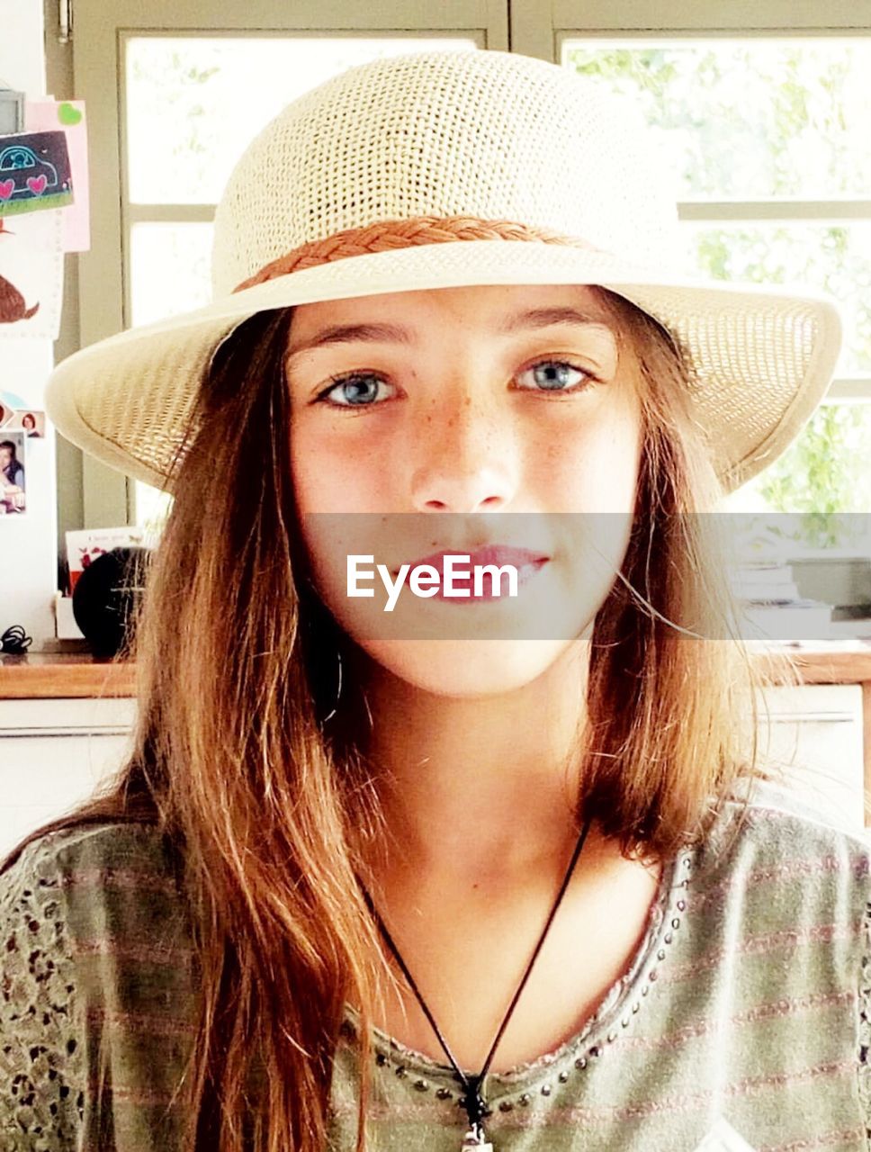 Portrait of girl in hat at home