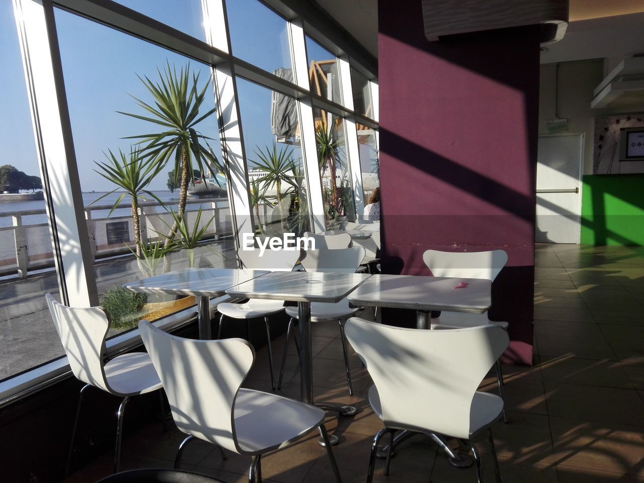 EMPTY CHAIRS AND TABLE AT RESTAURANT