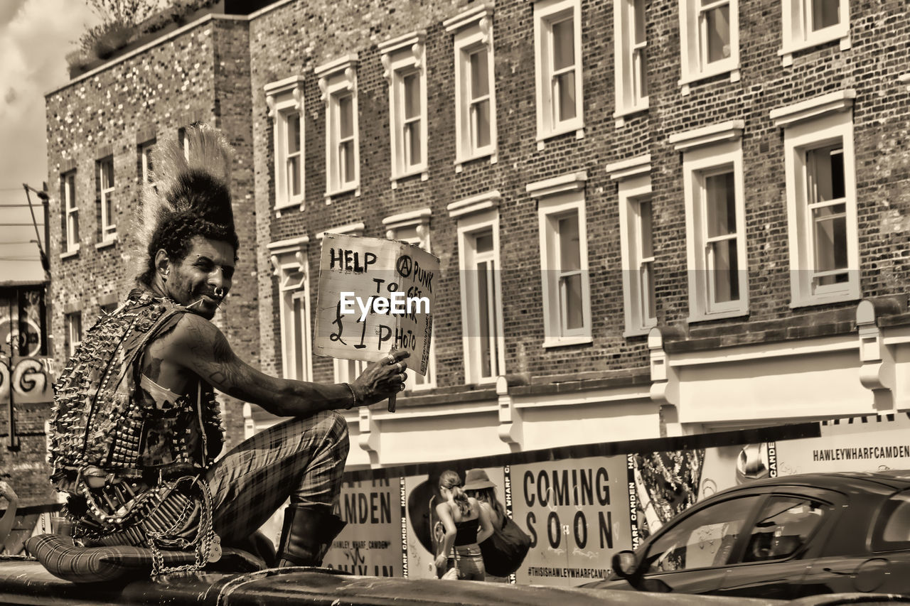 PEOPLE IN CITY AGAINST BUILDING