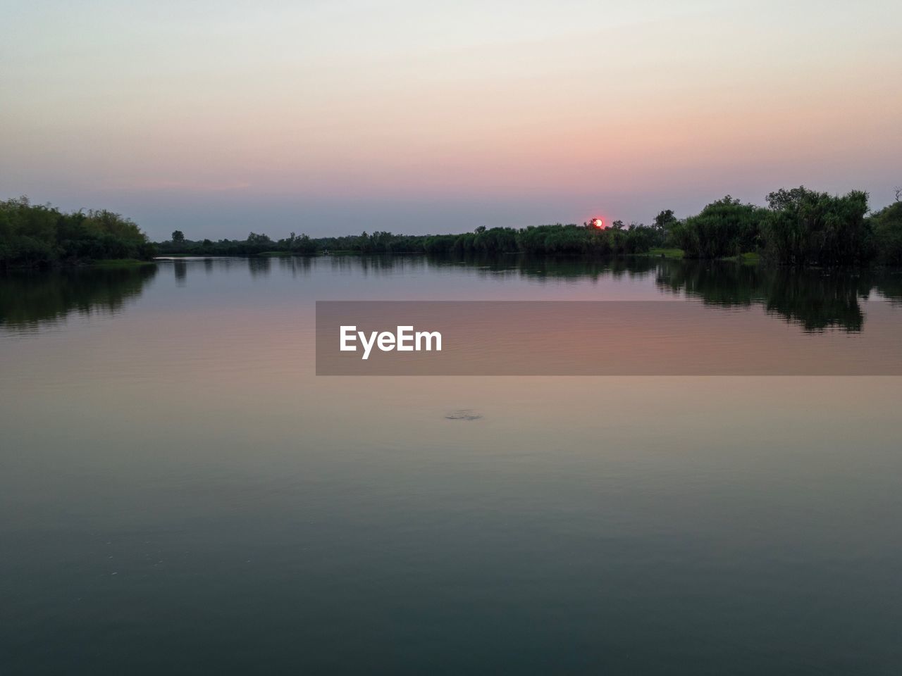 SCENIC VIEW OF LAKE AT SUNSET