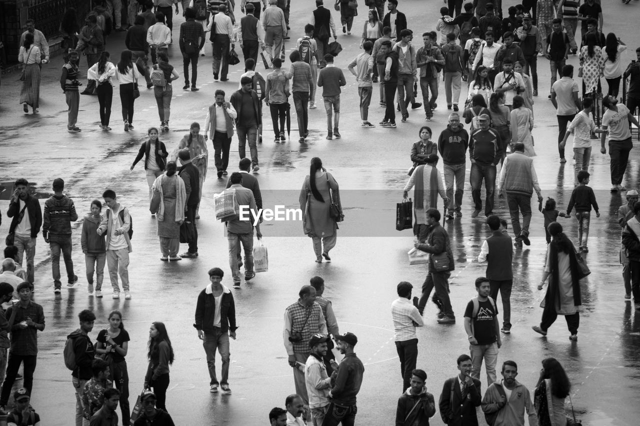 High angle view of people walking on street in city