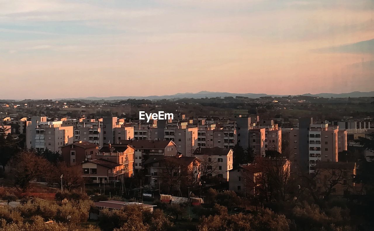 High angle view of buildings against sky during sunset