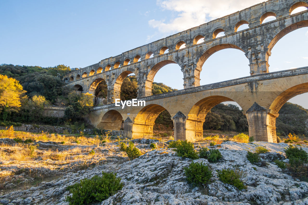 The magnificent pont du gard at setting sun. ancient roman aqueduct bridge.  photography in france.