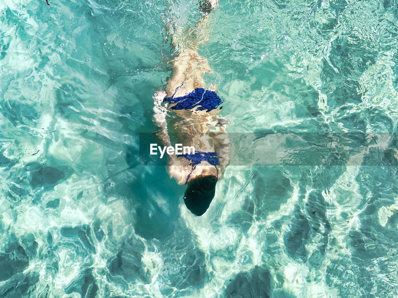 High angle view of girl swimming in sea