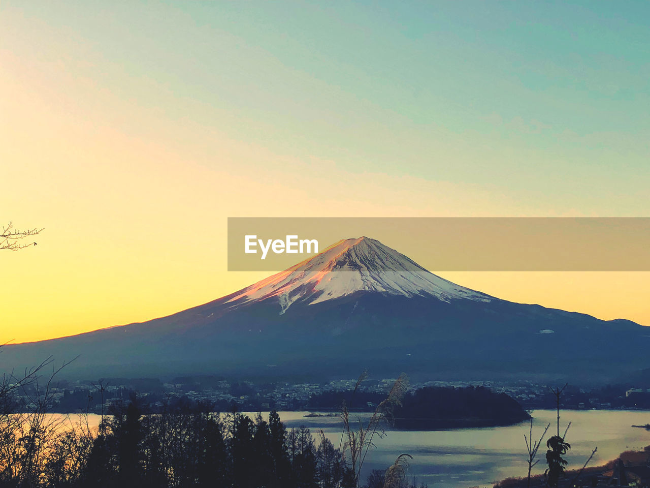 Scenic view of snowcapped fuji mountain against sky during dawn