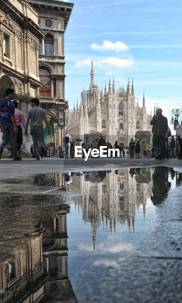 Milan cathedral reflecting on puddle