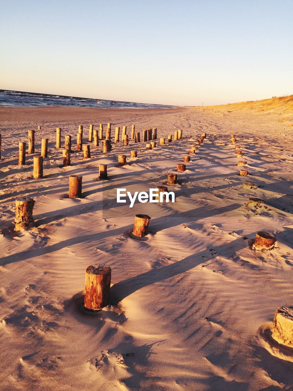 Scenic view of desert against clear sky during sunset