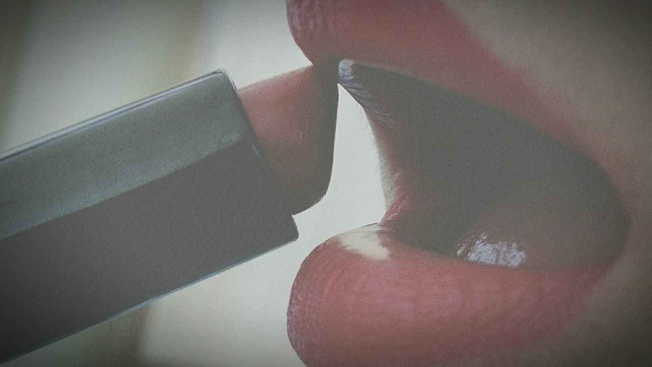 Close up of woman applying red lipstick