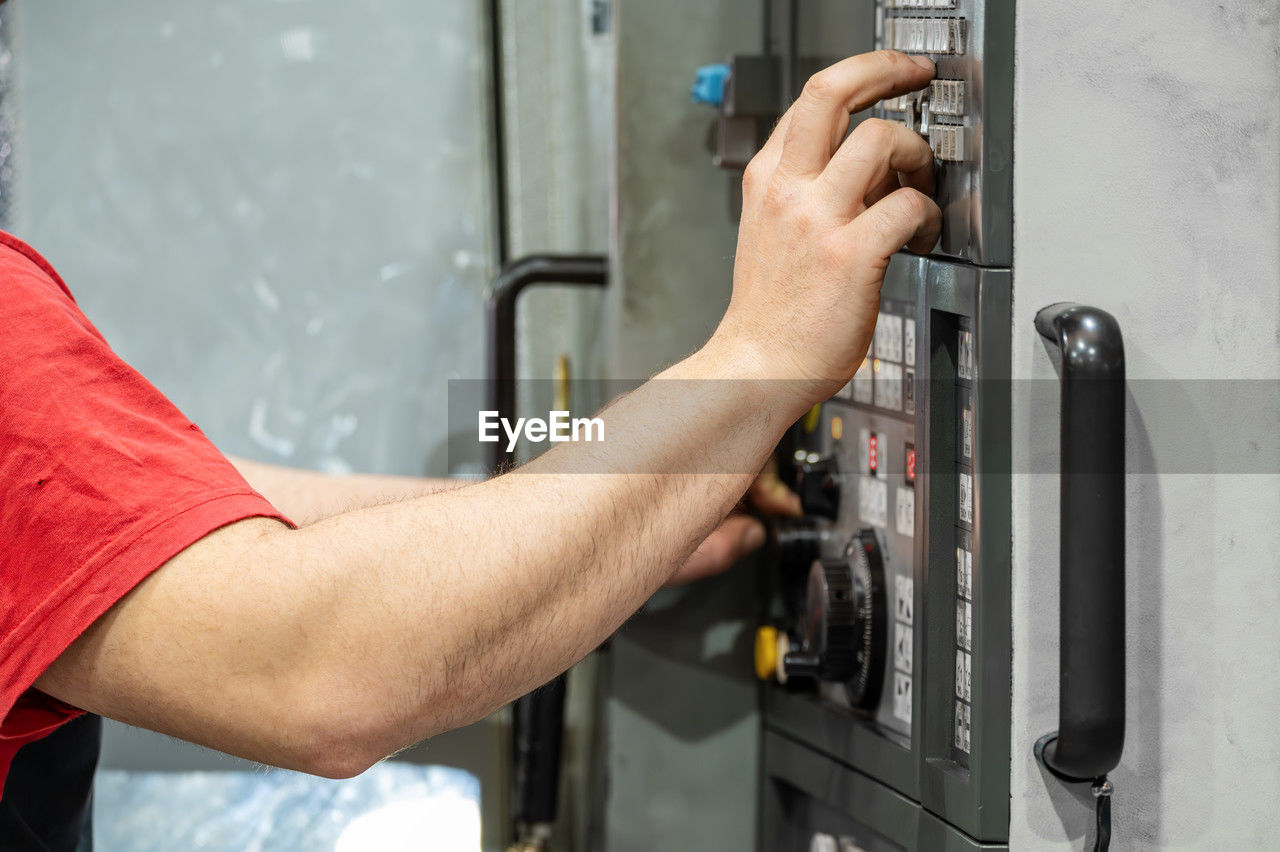 cropped hand of man working in workshop