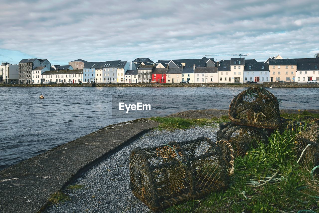 Beautiful scene with fishing nets on docks and colourful houses at claddagh, galway city, ireland