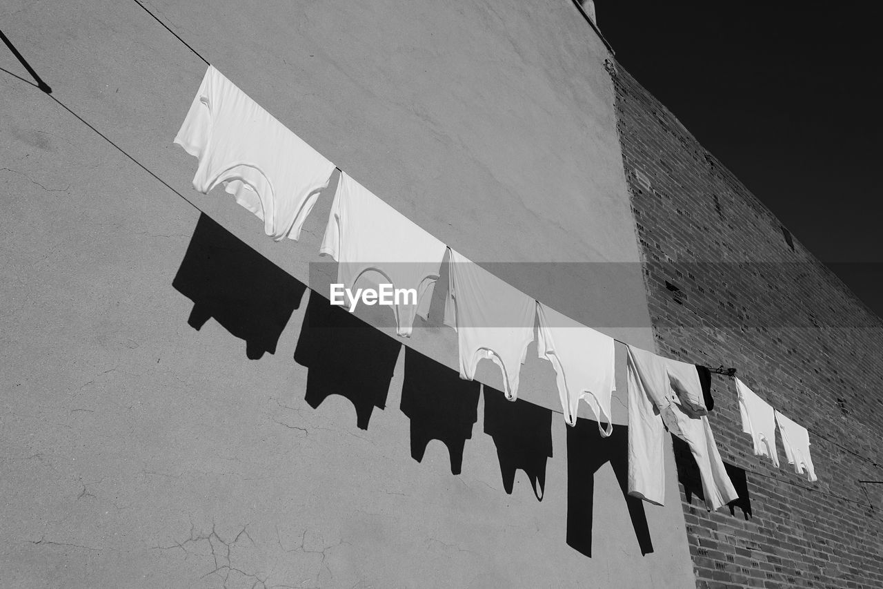 Low angle view of clothes drying against building