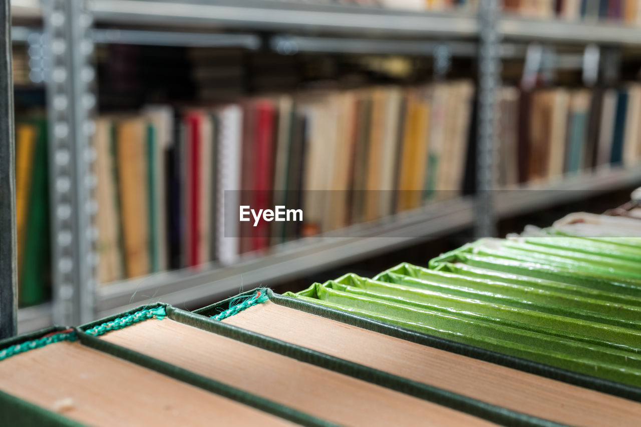 CLOSE-UP OF BOOKS IN LIBRARY