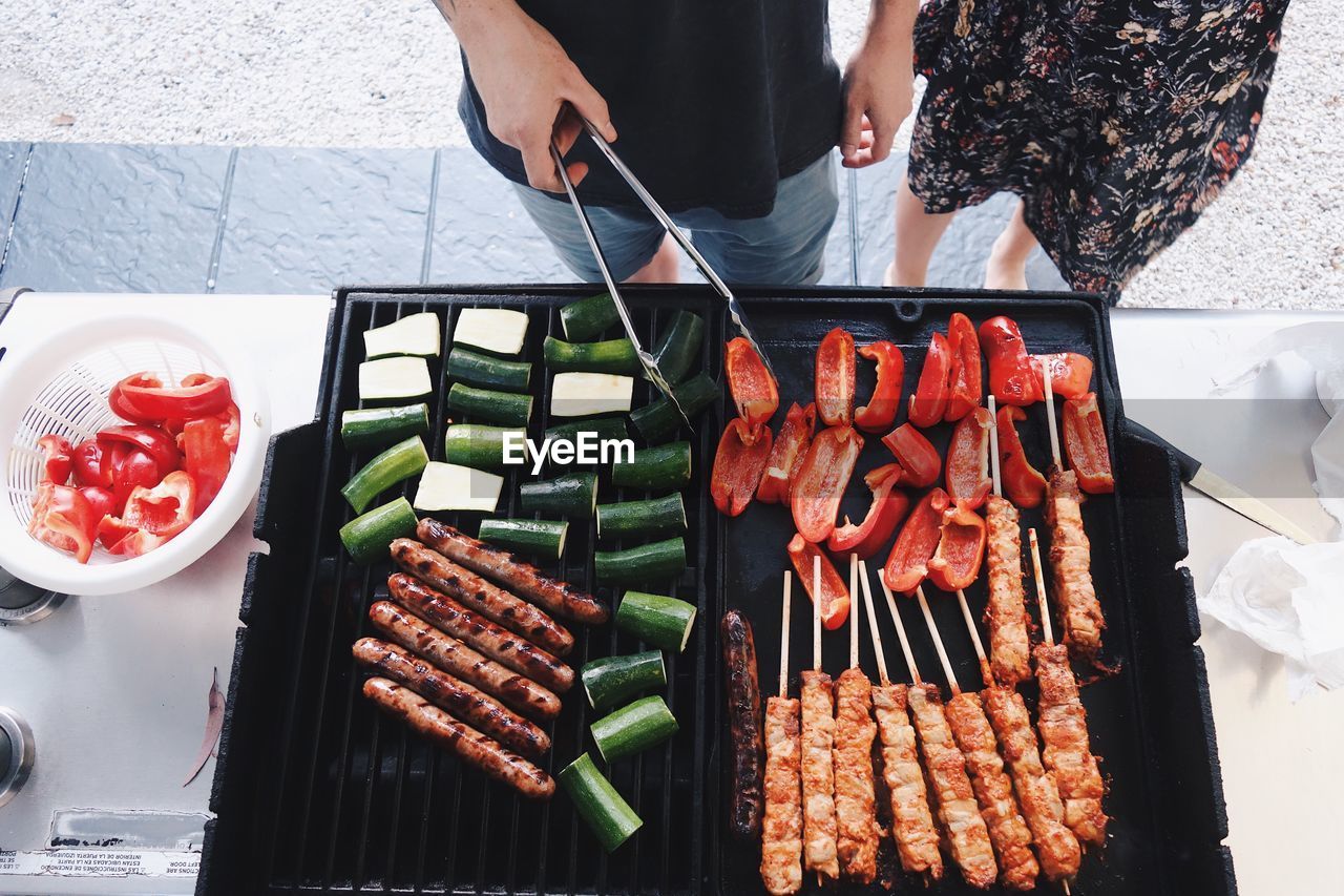 Midsection of people preparing food