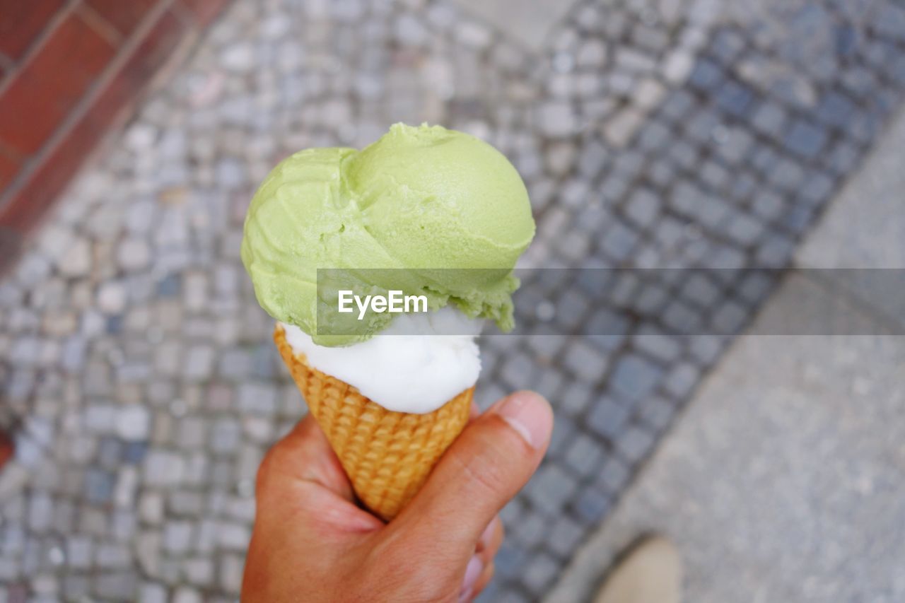 Close-up of hand holding ice cream cone