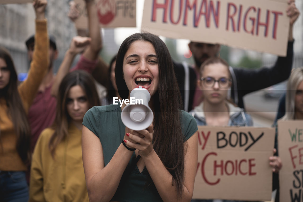 Group of protestors with their signs raised up in the air