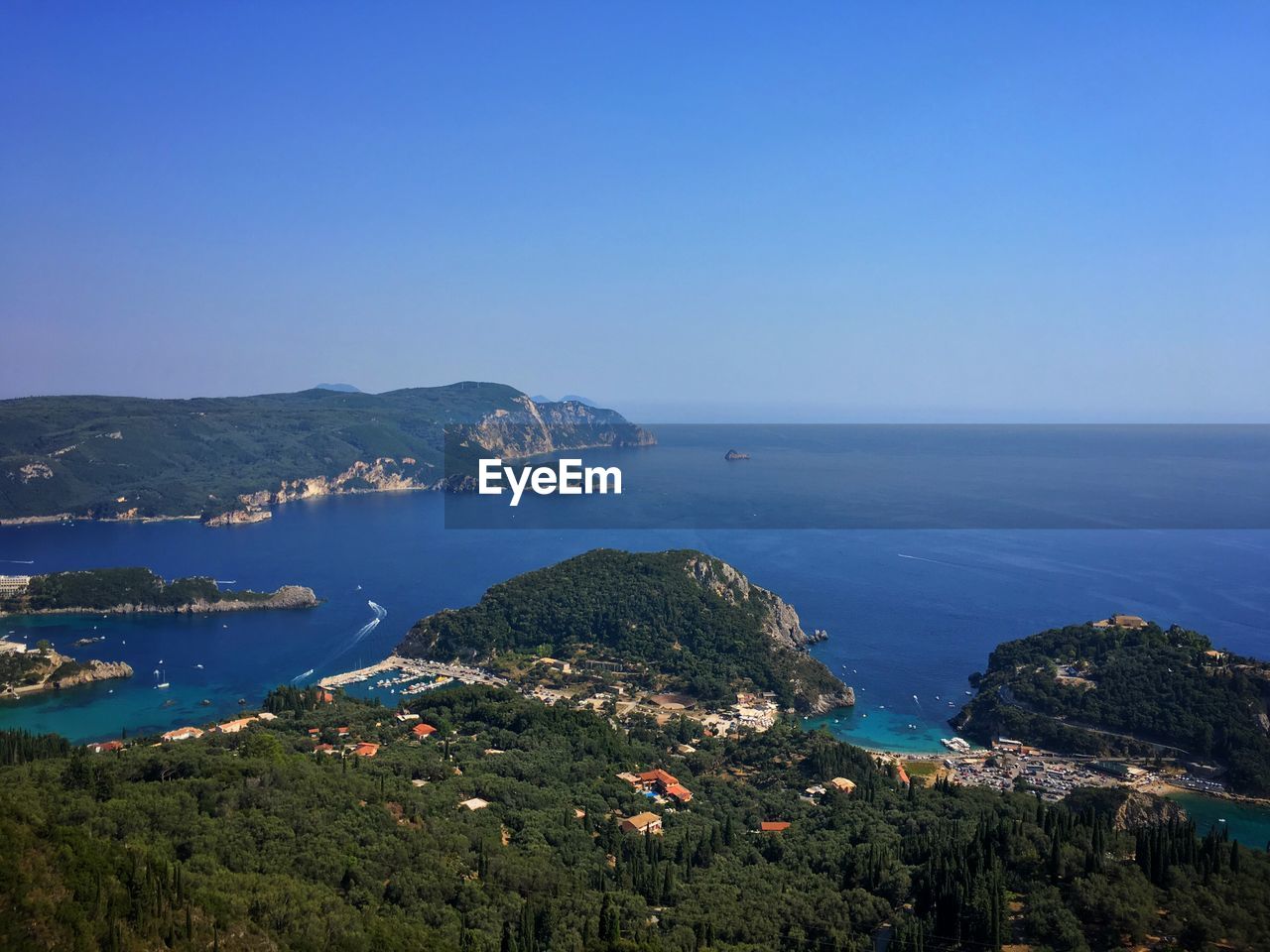 High angle view of bay against clear blue sky