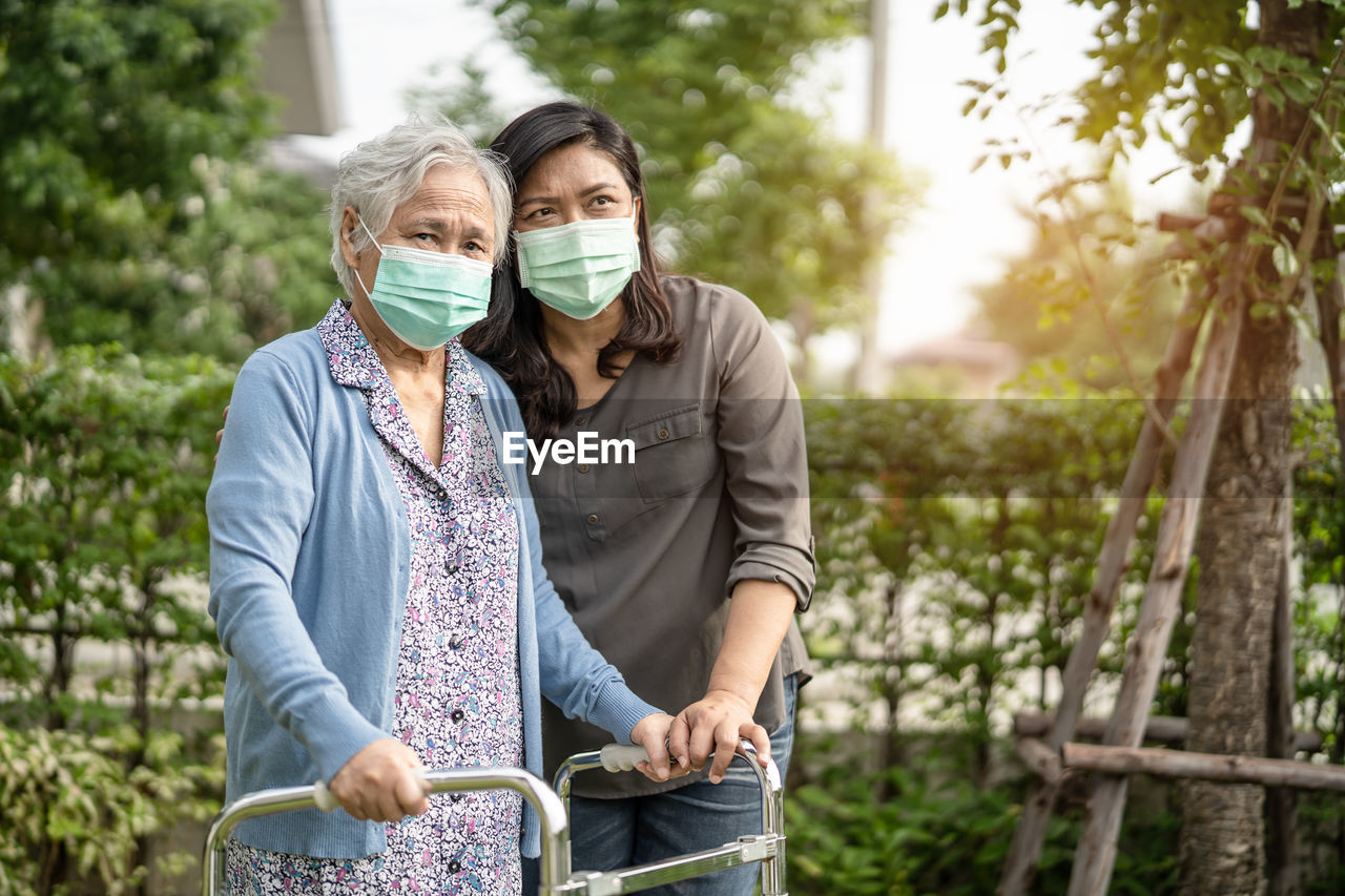 YOUNG COUPLE STANDING AGAINST BLURRED BACKGROUND