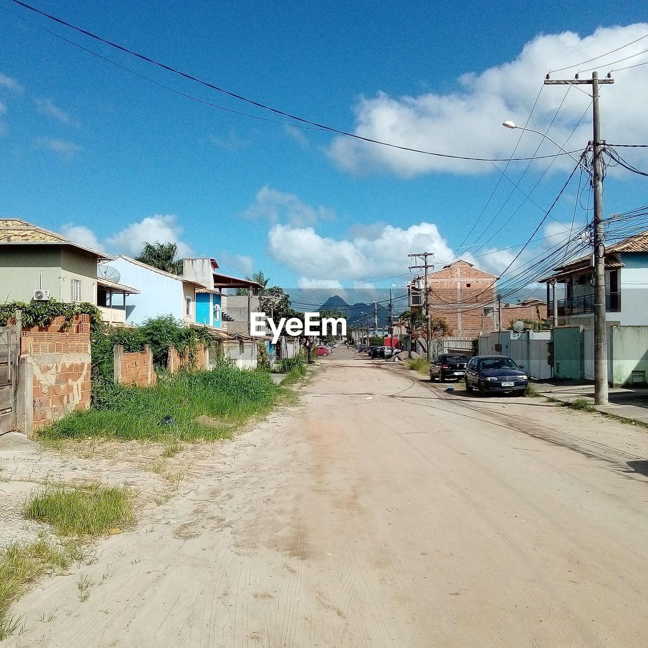 ROAD BY BUILDINGS AGAINST SKY