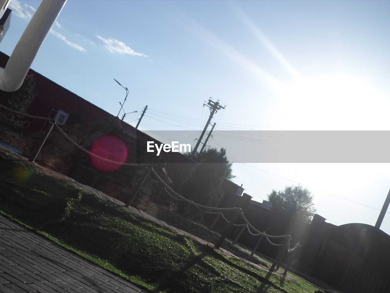 LOW ANGLE VIEW OF ELECTRICITY PYLONS ON LANDSCAPE AGAINST SKY