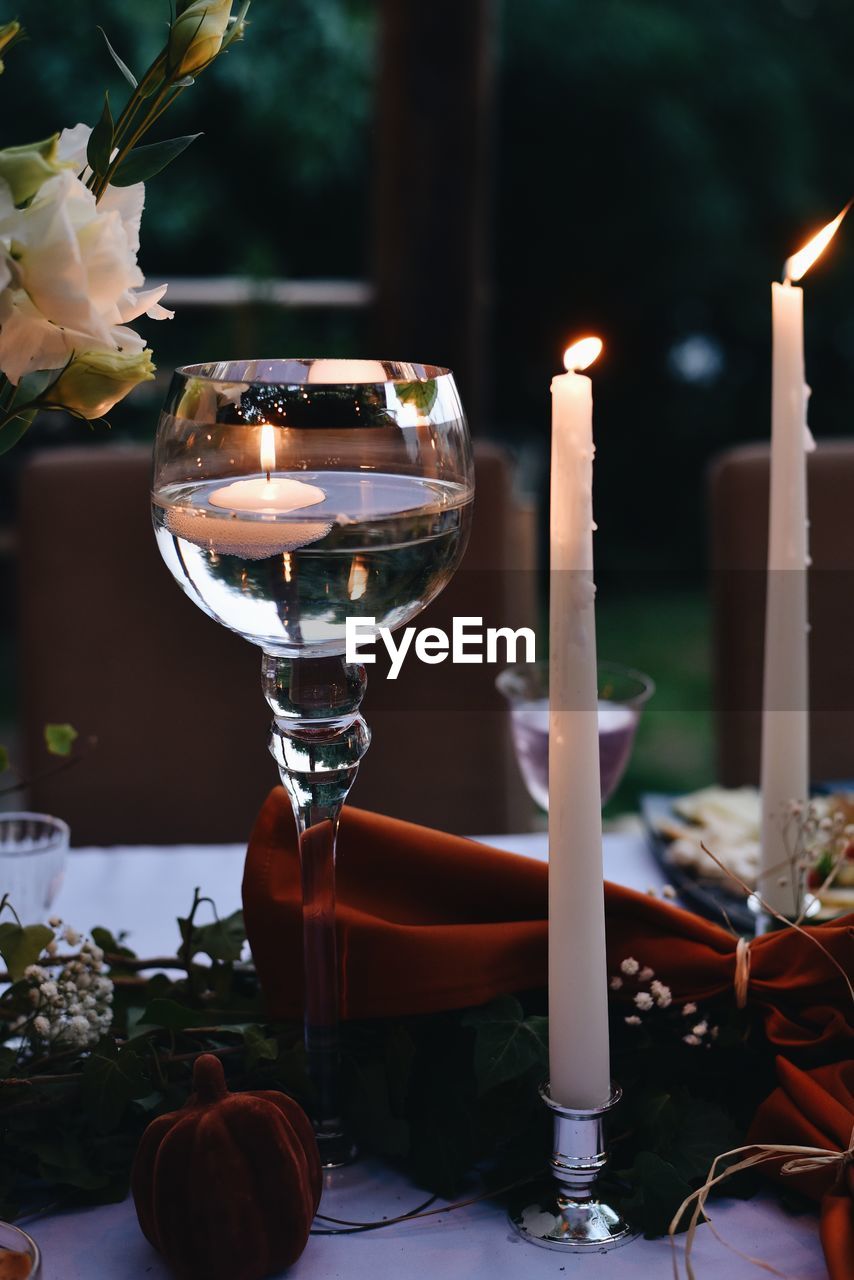 Close-up of lit candles on table