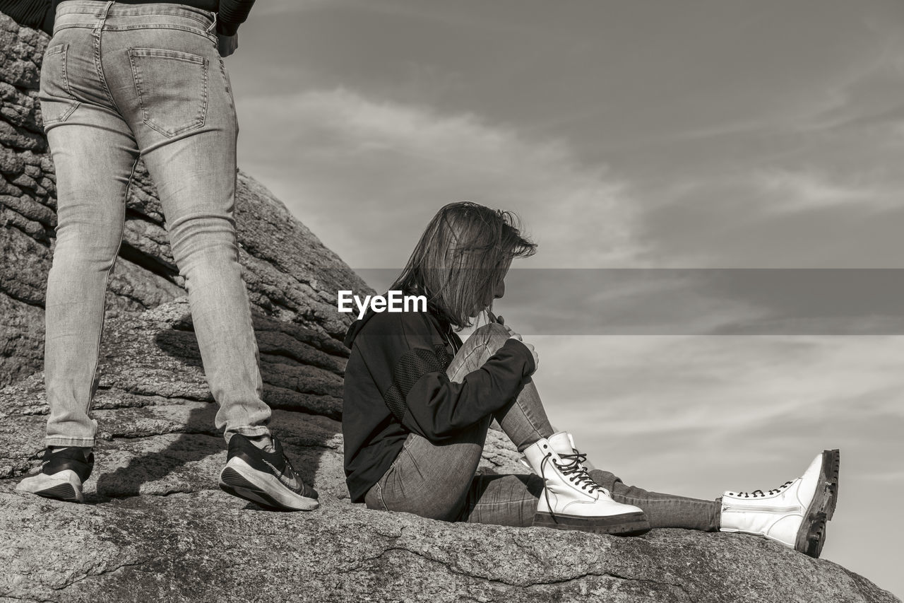 white, sky, footwear, sitting, adult, nature, cloud, leisure activity, lifestyles, casual clothing, black and white, black, monochrome, one person, women, shoe, relaxation, monochrome photography, photo shoot, person, day, full length, clothing, outdoors, land, child, men, activity, young adult, female, human leg, sunlight, childhood