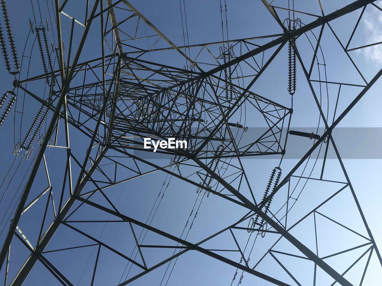 LOW ANGLE VIEW OF ELECTRICITY PYLONS AGAINST CLEAR SKY