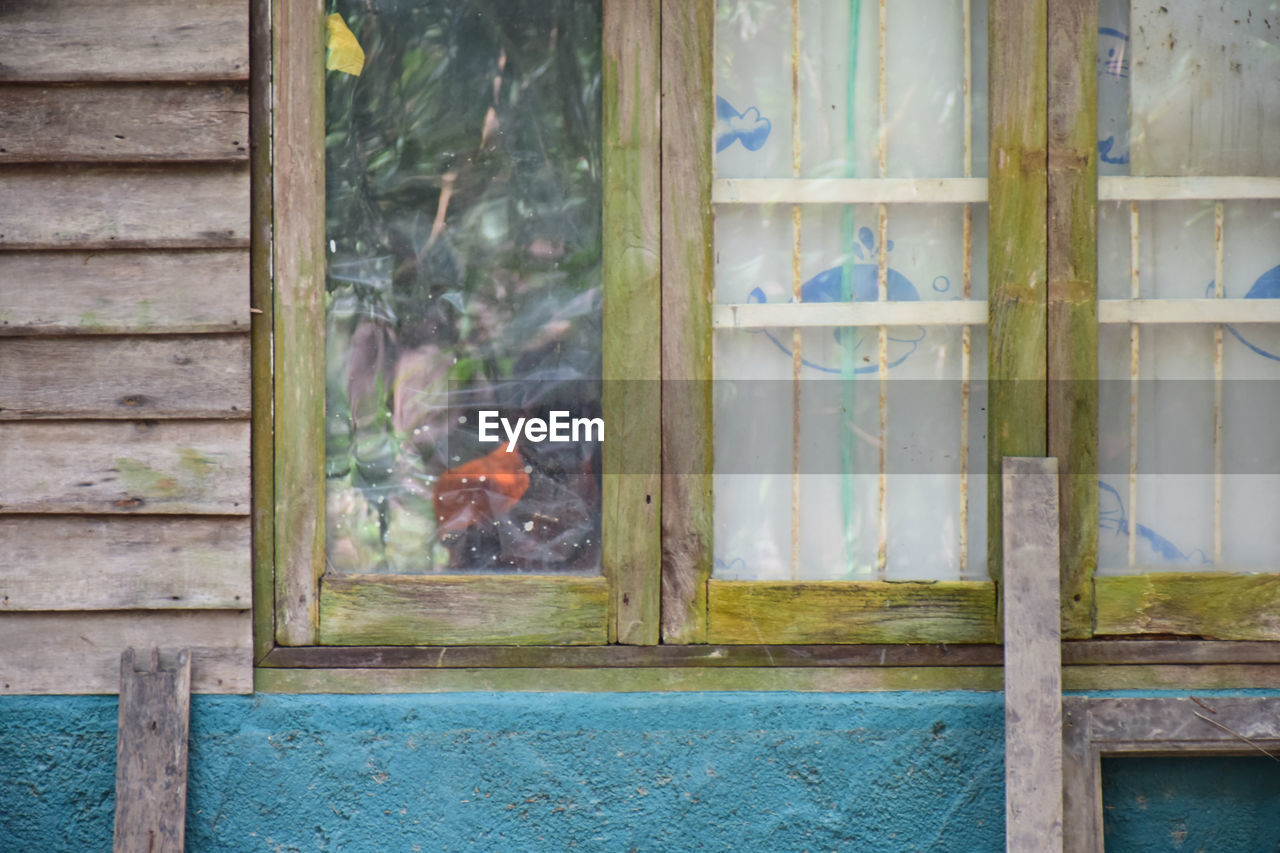 WINDOW ON WOODEN WALL