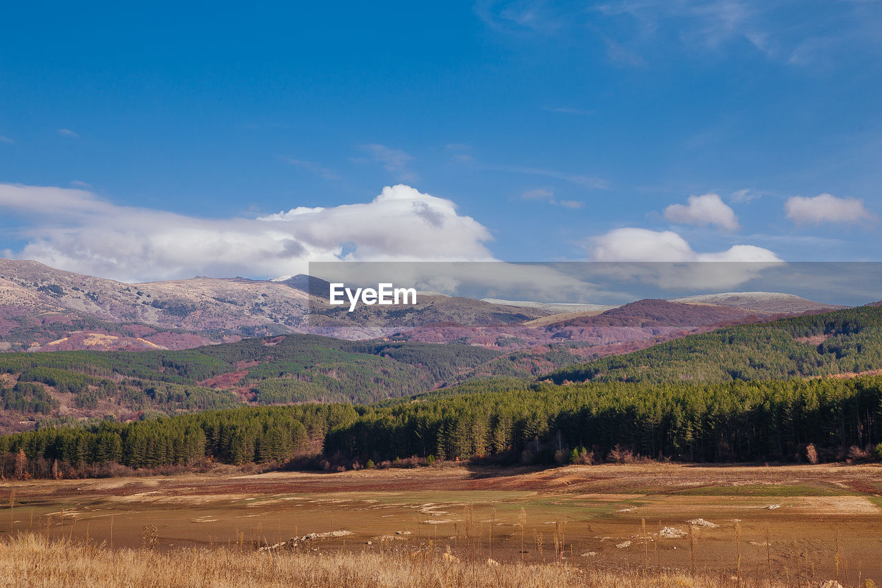 SCENIC VIEW OF LANDSCAPE AGAINST BLUE SKY