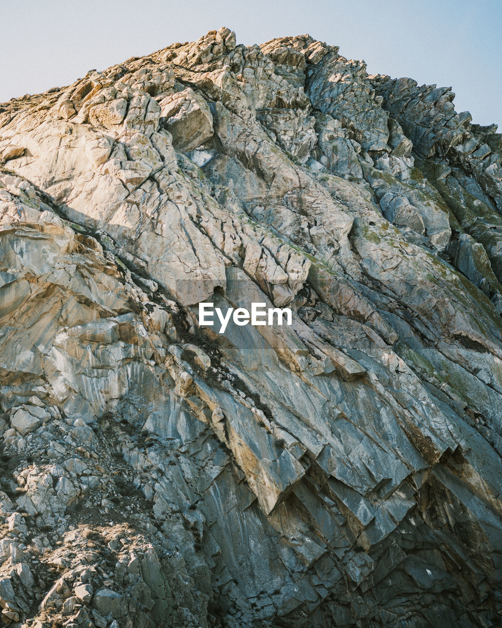 LOW ANGLE VIEW OF ROCK FORMATION AGAINST SKY