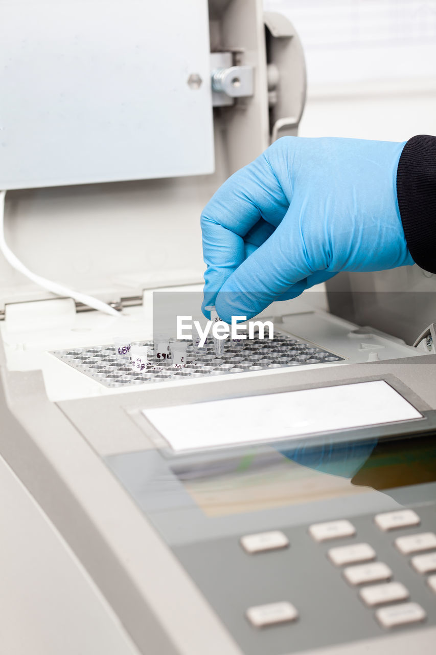 Scientist working at the laboratory with a thermal cycler. polymerase chain reaction technique. 