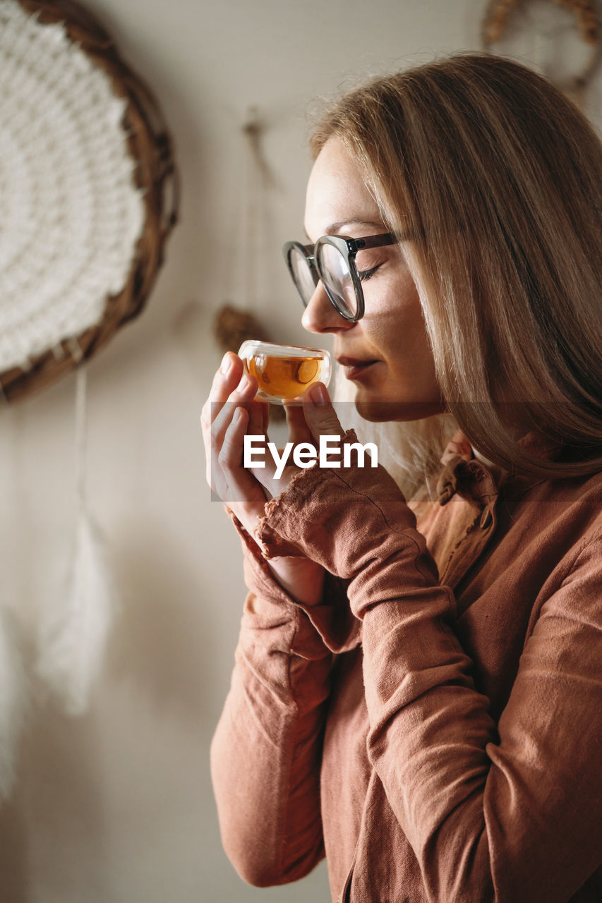 Women preparing tea ceremony in boho style atmospheric room warm drink in hands oolong chinese drink