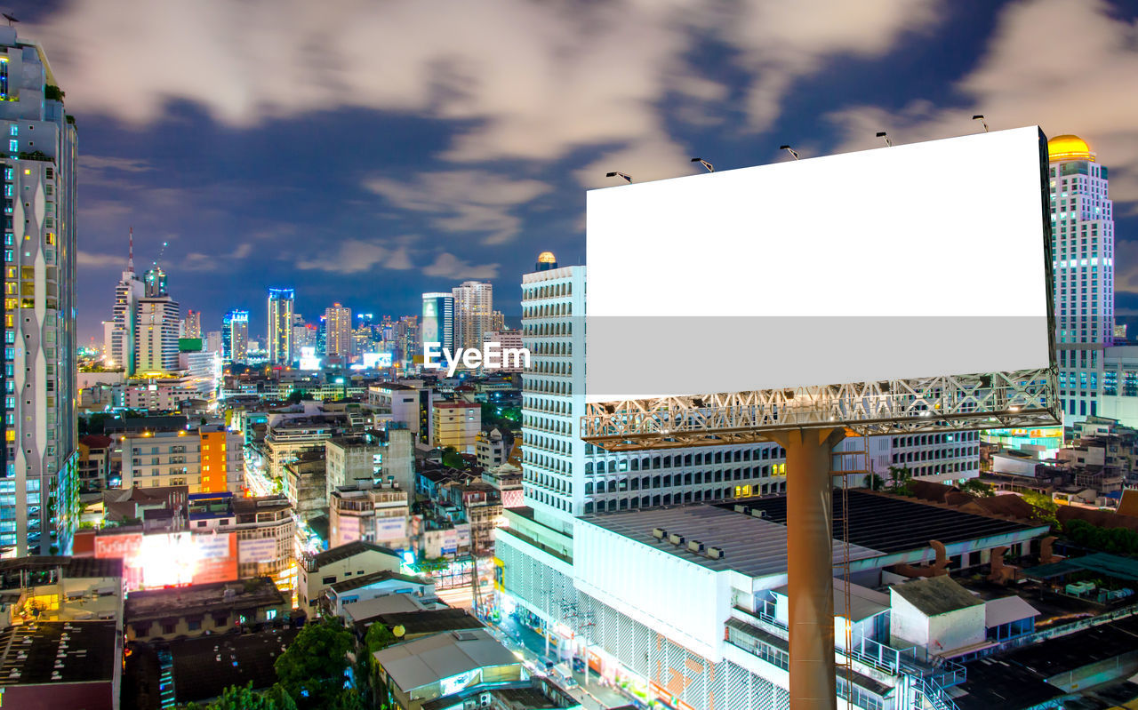 High angle view of illuminated buildings against sky in city