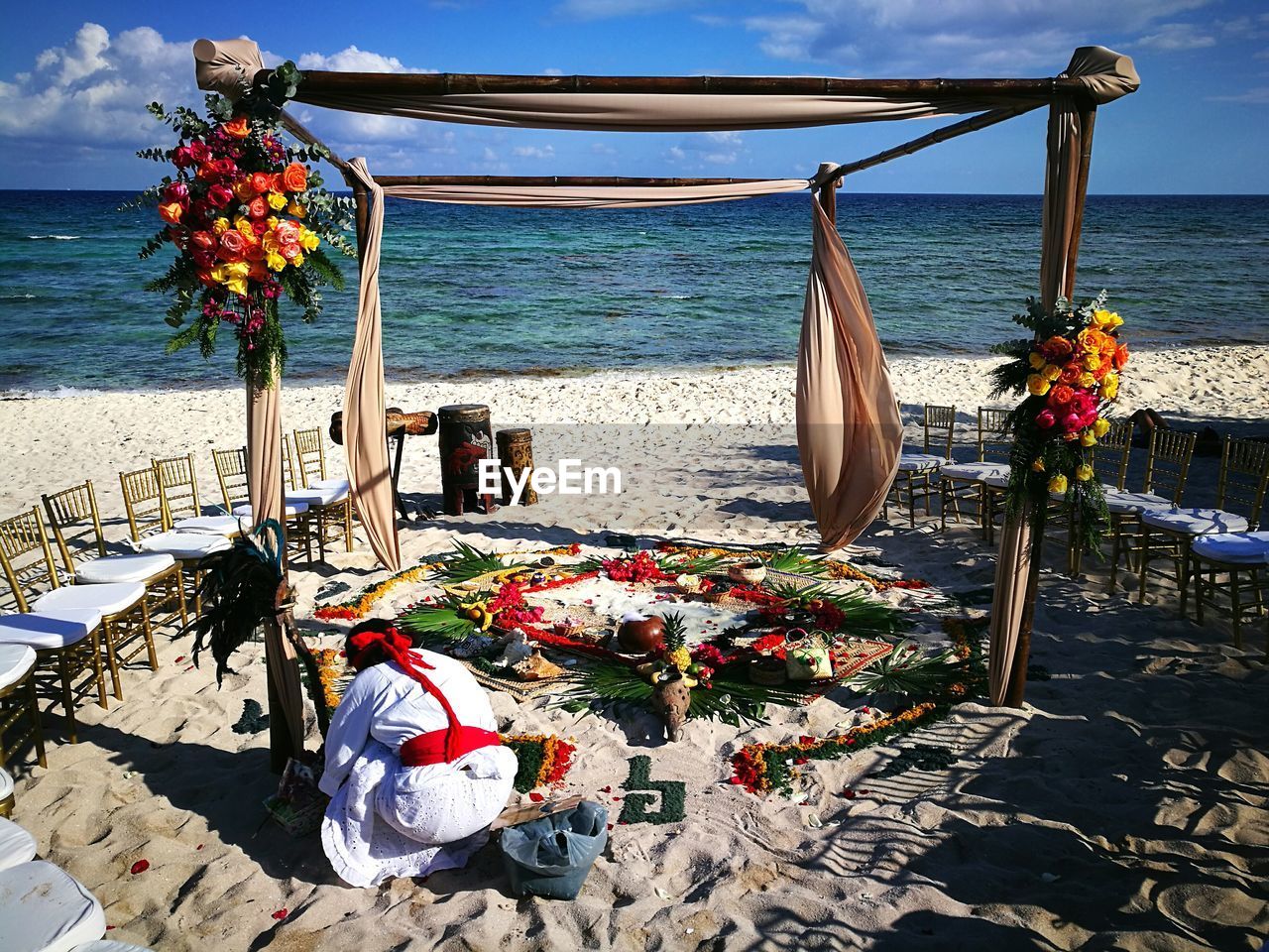 Close-up of deck chairs on beach against sea