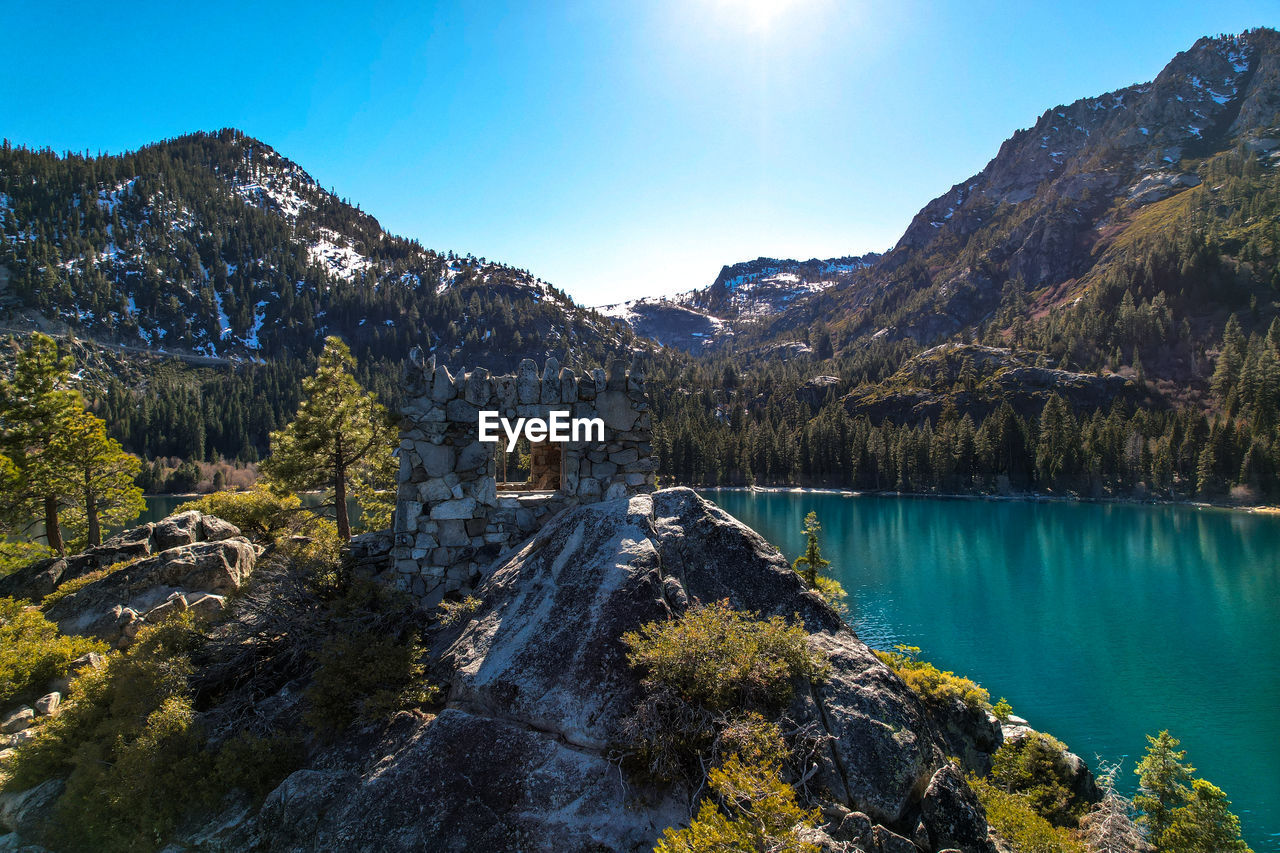 Scenic view of emerald bay by mountains against sky