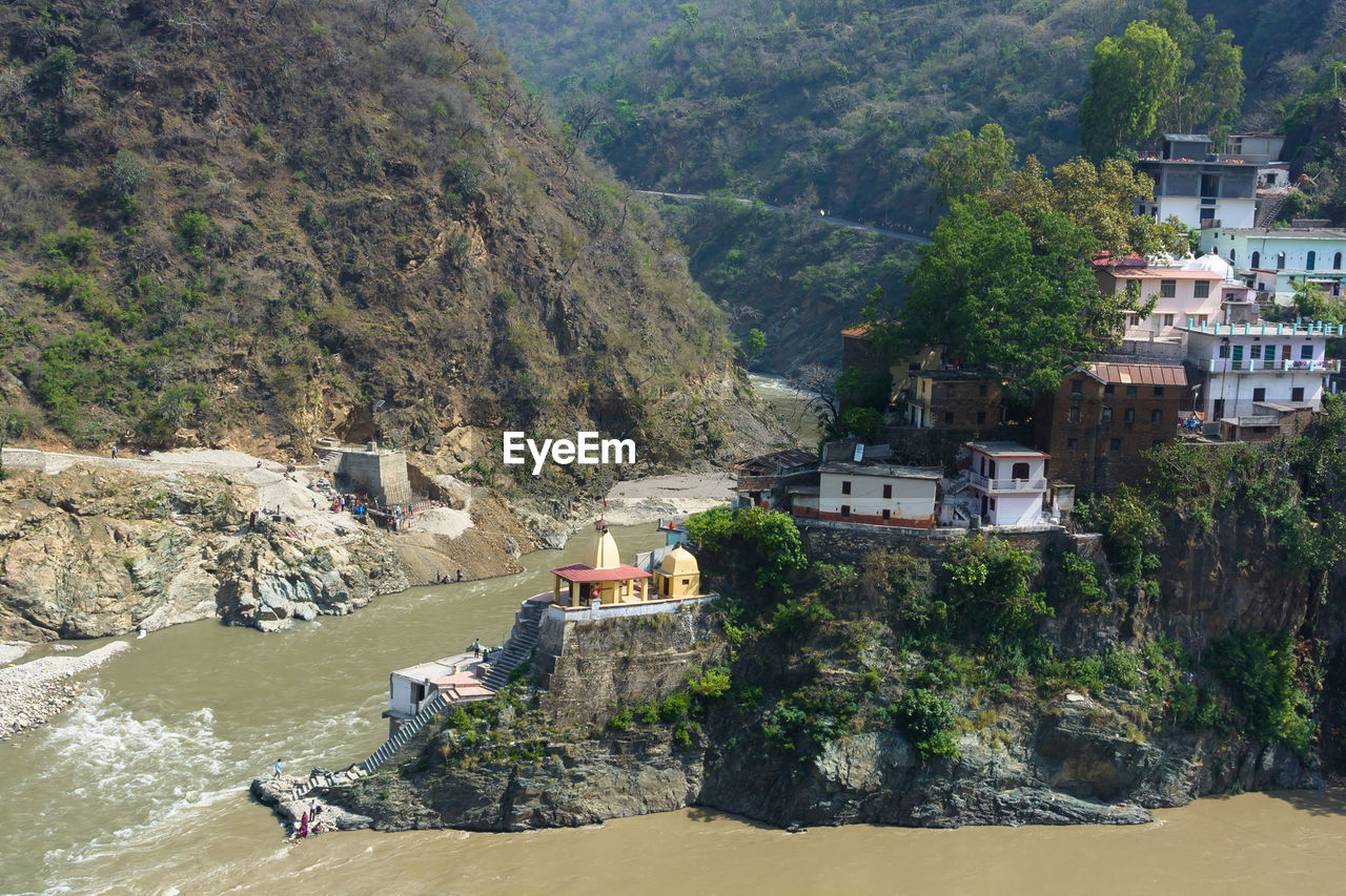 architecture, built structure, tree, mountain, building exterior, water, nature, plant, land, building, high angle view, day, river, coast, scenics - nature, beauty in nature, house, outdoors, beach, travel destinations, travel, environment, no people, residential district, mountain range, tourism, rock, landscape, vacation, sunlight, town, aerial photography, city, cliff, village