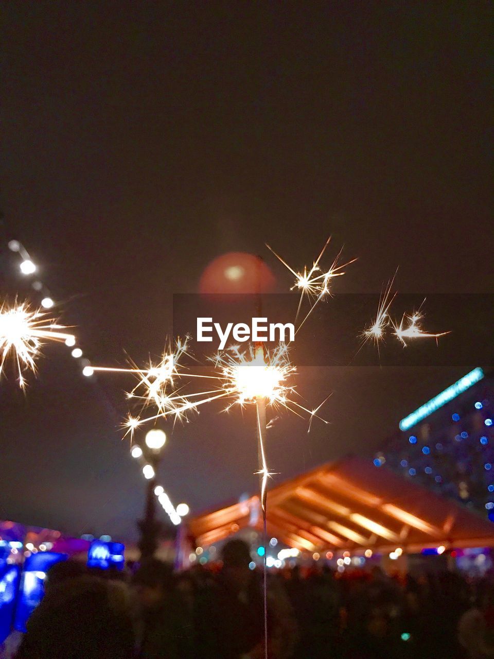 FIREWORKS IN SKY OVER ILLUMINATED FIRE