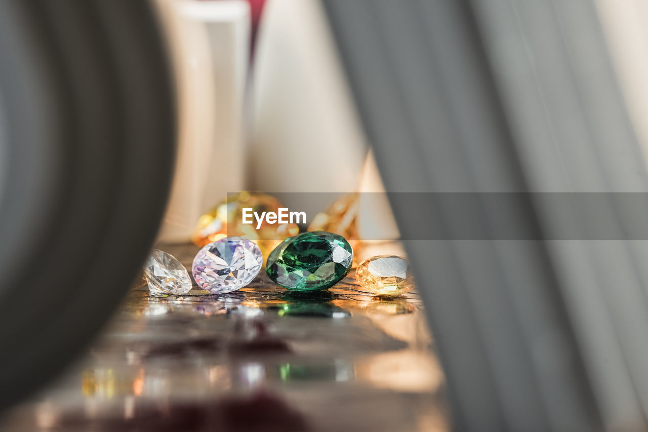 selective focus, jewelry, diamond, indoors, wealth, luxury, close-up, no people, ring, celebration, precious gem, yellow, still life, shiny, fashion accessory, focus on background, macro photography