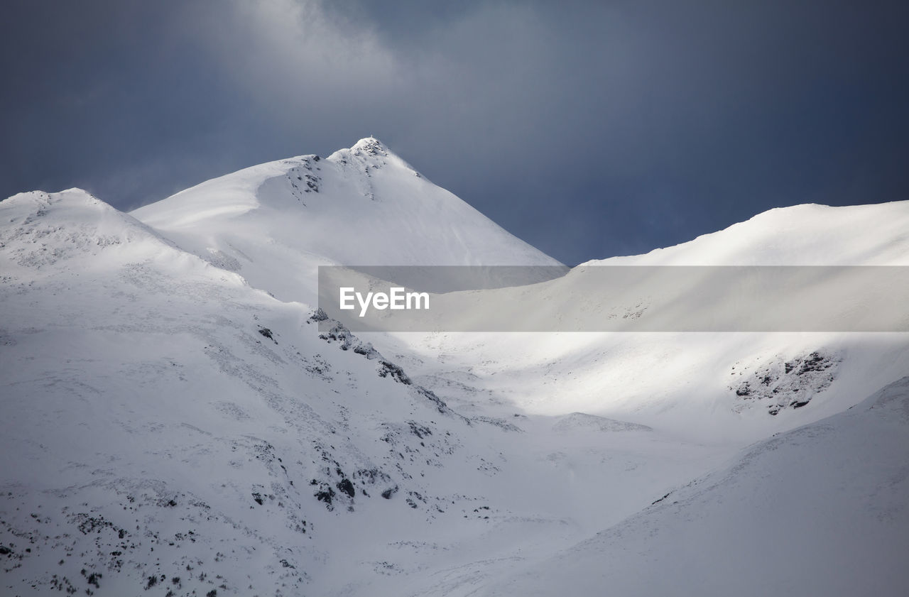 Scenic view of snow covered mountains against sky