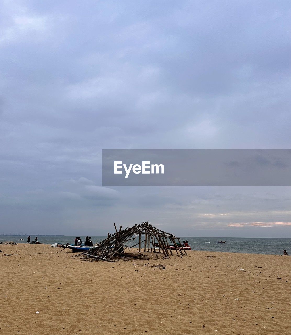 beach, land, sky, sea, water, sand, cloud, body of water, nature, beauty in nature, scenics - nature, hut, ocean, shore, horizon over water, tranquility, coast, holiday, horizon, tranquil scene, architecture, travel destinations, trip, vacation, built structure, day, outdoors, tourism, no people, coastline, travel, man made structure, seascape, environment, lifeguard hut, non-urban scene, idyllic